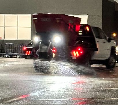 Treatment truck working a commercial lot at night