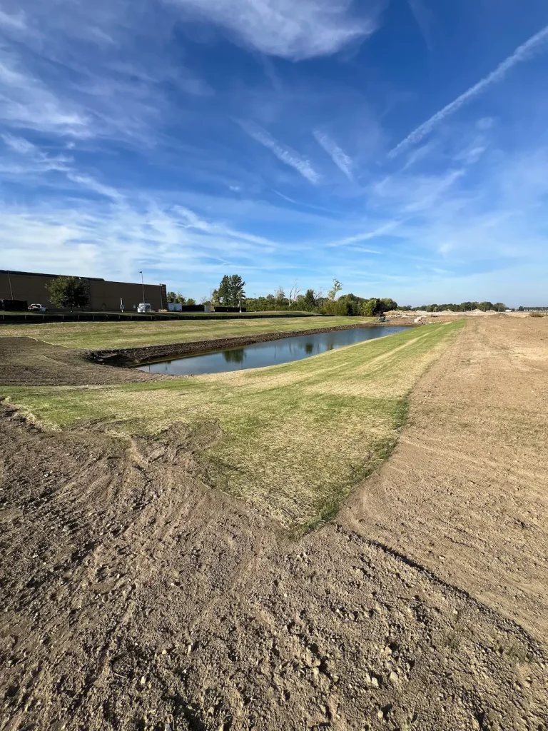Installing a seed and straw erosion blanket on a slope