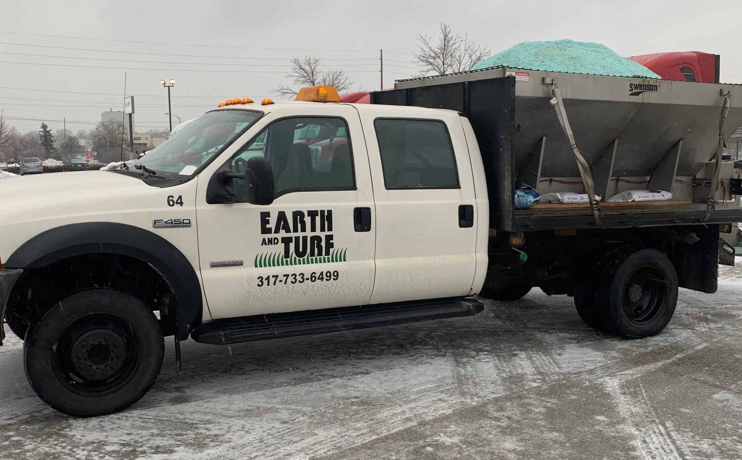 Earth and Turf work truck parked at a commercial property